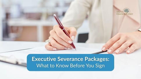 Executive reviewing severance package documents at a desk