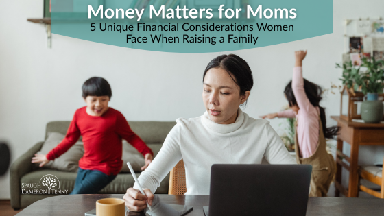 Mother reviewing family finances at kitchen table with laptop and coffee